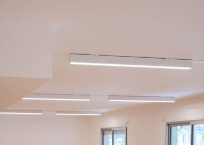 Éclairage linéaire contemporain installé dans des bureaux rénovés